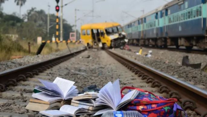 Damaged school vehicle after collision with a passenger train at a railway crossing in Murshidabad, West Bengal.